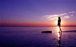 Girl at sunset sea